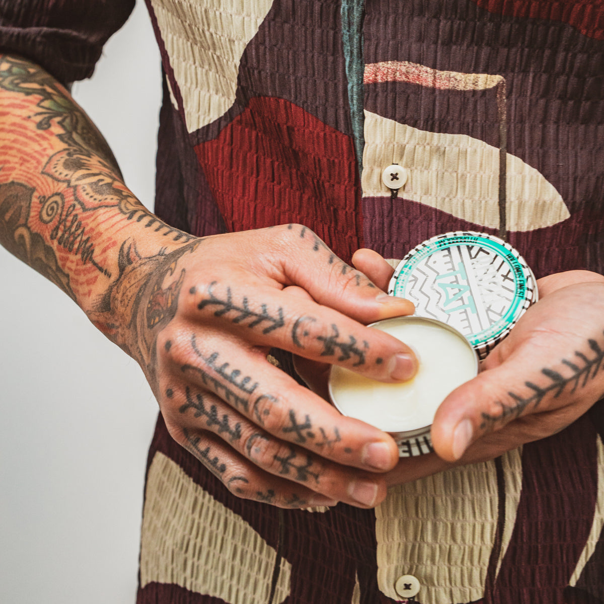 Reuzel TAT Hydrabalm tattoo aftercare product in a sleek jar, designed to soothe and hydrate freshly tattooed skin.