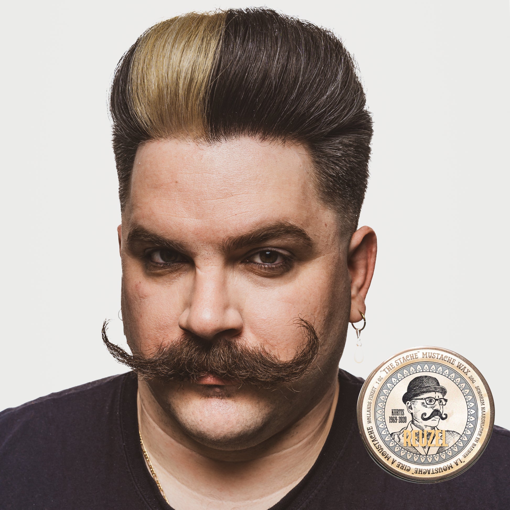 Reuzel The Stache Mustache Wax in a small jar, designed for shaping and styling mustaches and facial hair.