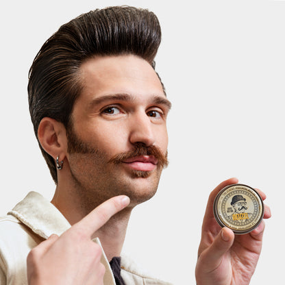 Reuzel The Stache Mustache Wax in a small tin, designed for shaping and styling mustaches with a natural finish.